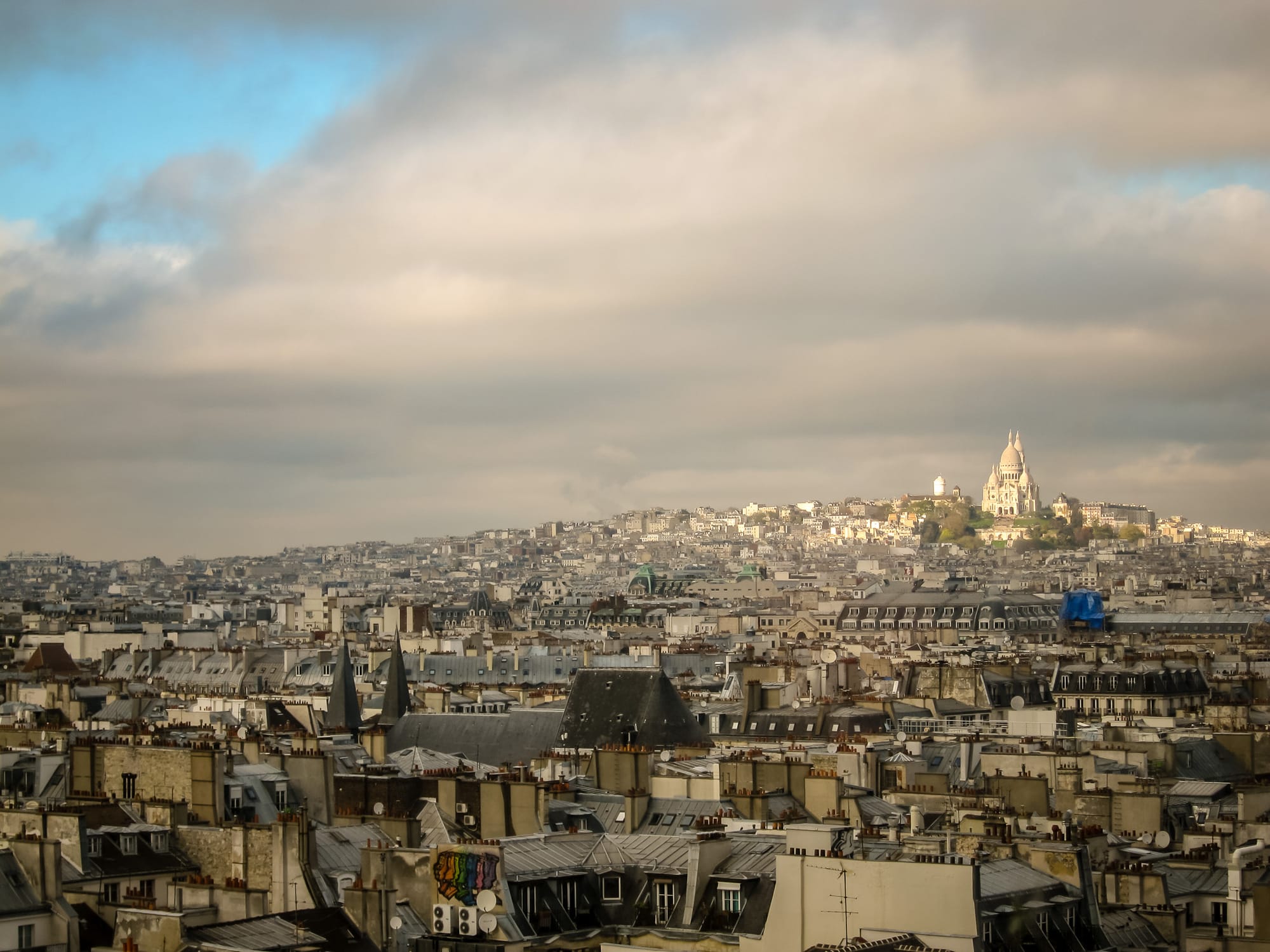 From the Pompidou rooftop, Paris stretches to Montmartre, with Sacré-Cœur glowing on the horizon, 2012.
